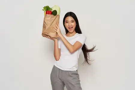Женщина с продуктами в упаковке, диета, калории, светлый фон