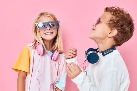 Портрет девочки и мальчика в наушниках для развлечений, играющих