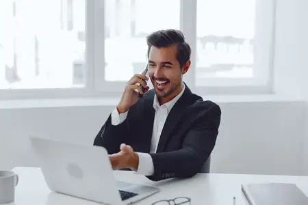 Мужчина европеоидной расы разговаривает по телефону, успешный менеджер и бизнесмен в помещении