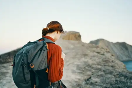 Счастливая женщина путешествует в горах на природе у моря, пейзаж, скалы, высокие камни