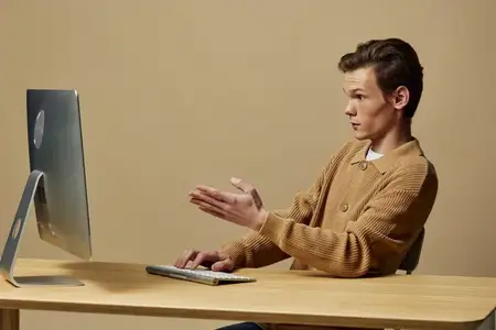Технически подкованный профессионал: портрет молодого красивого бизнесмена, работающего из дома за ноутбуком