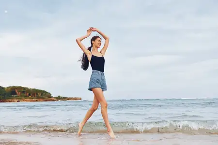 Молодая женщина наслаждается летним отдыхом на пляже