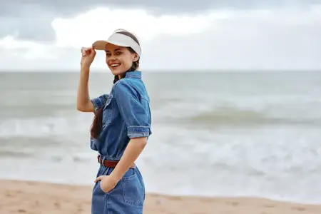 Летняя красота: молодая женщина наслаждается отпуском на пляже, погружаясь в безмятежность океана