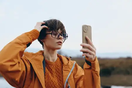 Женщина делает селфи на смартфон на открытом воздухе
