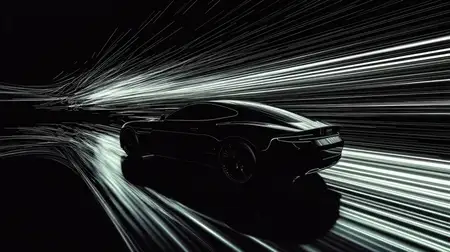 Современный черный спортивный автомобиль, снятый в движении, с яркими световыми полосами, передающими скорость и энергию