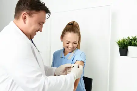 Врач-мужчина в белом халате заботится о пациенте в больнице, проводит лечение