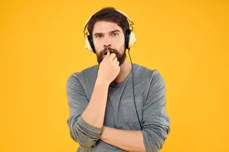 Мужчина в наушниках, музыка, образ жизни, технологии, жёлтый фон