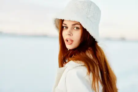 Симпатичная женщина в белом пальто и шапке, зимний пейзаж, прогулка на природе