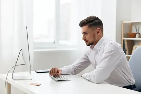 Красивый мужчина, офисный работник в белой рубашке, испытывает эмоции на фоне технологий