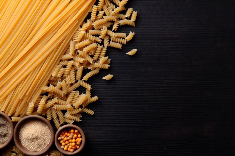 pasta uncooked food ingredient healthy background vegan raw italian macaroni spaghetti. Generative AI.