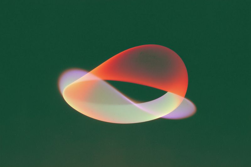 Grainy abstract light ribbon swirling against a deep green background, creating a luminous colorful loop with soft blur and neon gradient for modern artistic visuals.