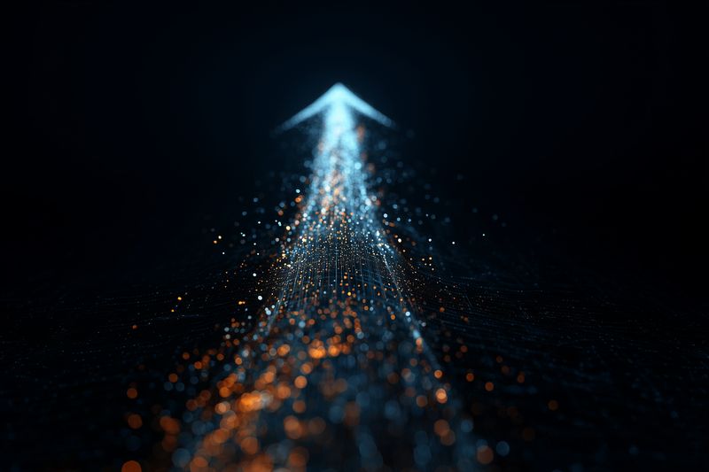 A glowing arrow crafted from blue and orange particles rises through dark space, conveying upward direction, digital progress, momentum and dynamic motion with soft bokeh light effects.