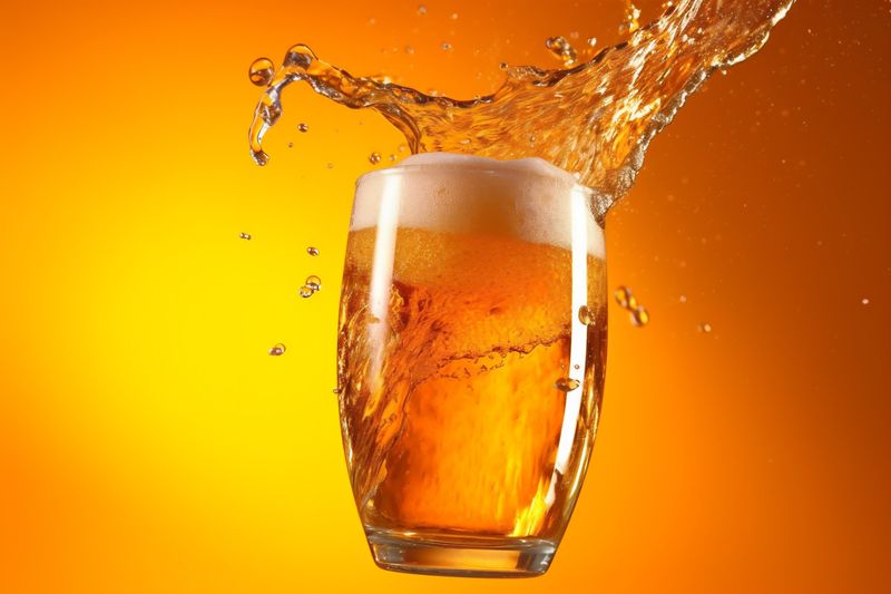 foam gradient beer splash alcohol bubble drink spill cold glass background. Generative AI.