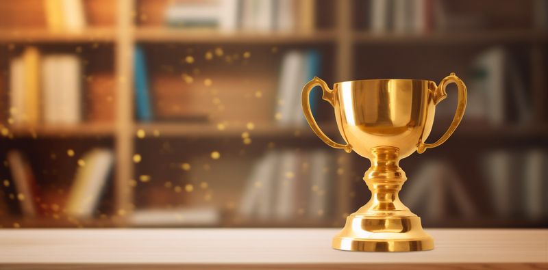library celebration gold cup award prize trophy champion competition bokeh. Generative AI.