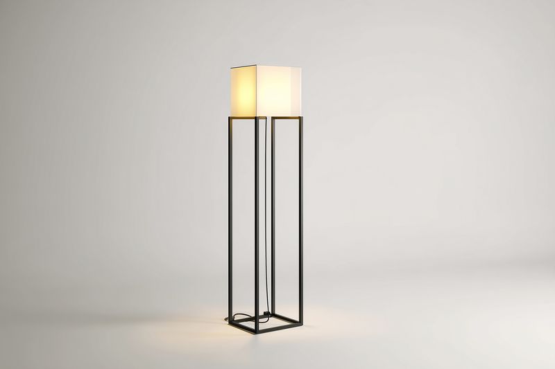 Minimal modern floor lamp with geometric metal frame and soft fabric shade standing on a neutral backdrop. Warm ambient glow enhances a calm, elegant contemporary interior mood.