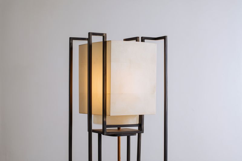 Contemporary floor lamp with a rectangular paper shade and slim metal frame casting a warm ambient glow, ideal for minimalist interiors and cozy living spaces and corners.