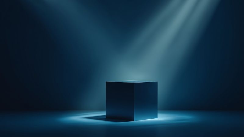 Minimal dark cube illuminated by dramatic blue spotlights in a moody studio setting, highlighting geometric form, contrast, reflection and deep shadows for modern concept or product imagery.